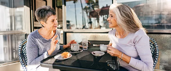 two women having coffee on patio